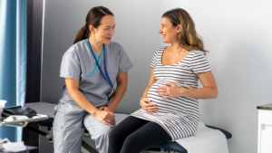 A midwife consults with a pregnant woman in a healthcare setting.