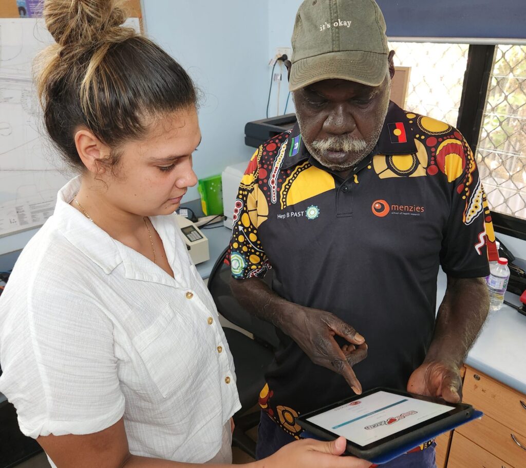 George Garambaka Gurruwiwi and Aaliyah Bailey, Project Assistant, discussing the Hep B Story App.