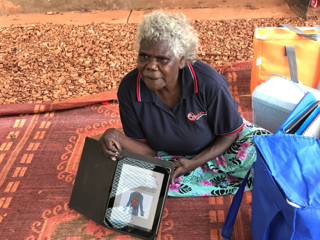 Roslyn Gundjirryirr Dhurrkay, Retired Menzies Aboriginal Community Worker, using the Hep B Story app in Yolŋu matha.