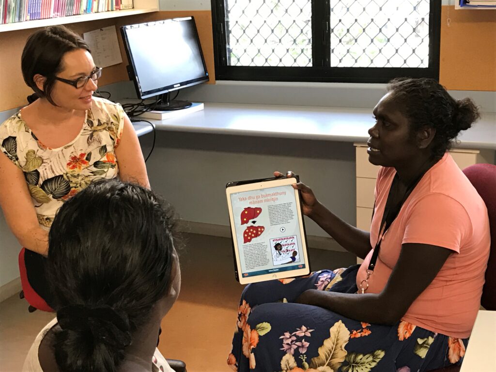 A/Prof Jane Davies and Senior AHP Sarah Bukulatjpi using the Hep B Story app in Yolŋu matha to explain hepatitis B.