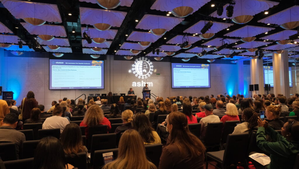 Photo of crowd watching presenter at Australasian Viral Hepatitis Conference 2025.